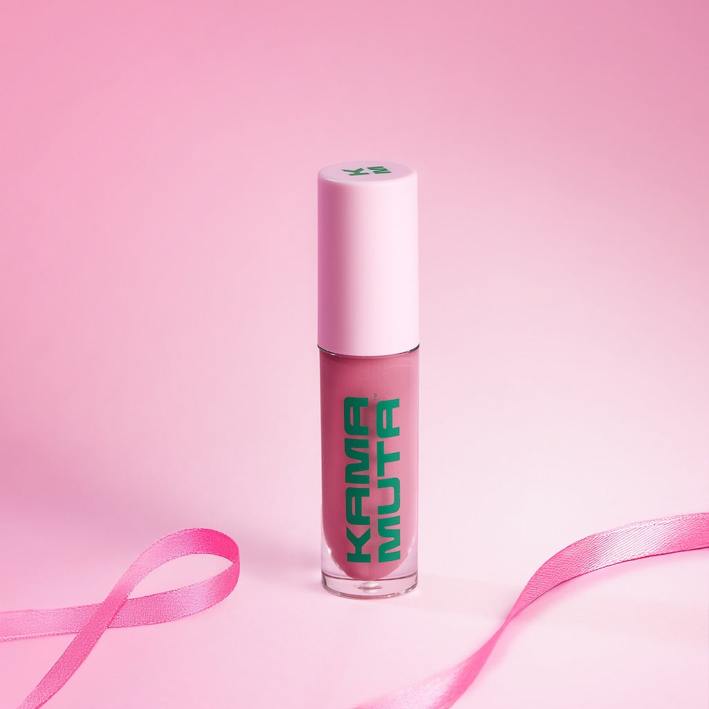 Lip gloss with 'Kama Muta' text on a pink background