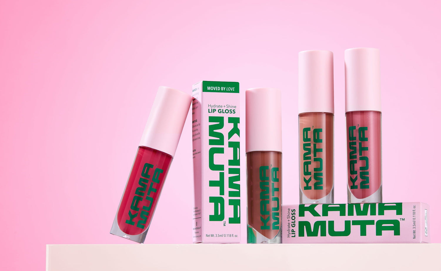 Kama Muta lip glosses on a pink background
